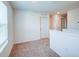 Neutral hallway featuring carpet, white walls, and multiple doors, providing access to different areas at 1303 Congo Ct, Kissimmee, FL 34759