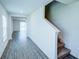 Hallway with wood-look floors leading to a staircase, and an open view of the living space at 1303 Congo Ct, Kissimmee, FL 34759
