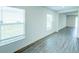 Hallway featuring wood-look flooring, bright natural light, and white trim throughout at 1303 Congo Ct, Kissimmee, FL 34759