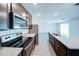 Open kitchen with stainless steel appliances, granite countertops, and views into the living space at 1303 Congo Ct, Kissimmee, FL 34759