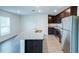 Bright kitchen with stainless steel appliances, granite island, and wood-look flooring at 1303 Congo Ct, Kissimmee, FL 34759