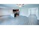 Open floor plan with wood-look floors, ceiling fan, and a kitchen area with stainless steel appliances at 1303 Congo Ct, Kissimmee, FL 34759