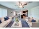 Open-concept living room featuring hardwood floors, modern decor, and a view of the kitchen at 1303 Congo Ct, Kissimmee, FL 34759