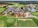Aerial view of a golf course community featuring a clubhouse, pool, tennis courts, and lush landscaping at 137 Drayton Ave, Davenport, FL 33837