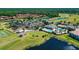 Beautiful aerial view of the golf course community with a clubhouse, pool, and multiple buildings at 137 Drayton Ave, Davenport, FL 33837