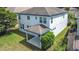 Overhead view of the back exterior with a patio, lawn, and surrounding landscaping at 137 Drayton Ave, Davenport, FL 33837