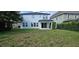 Large backyard featuring a covered patio and lush green lawn, great for outdoor activities at 137 Drayton Ave, Davenport, FL 33837