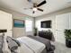Bedroom featuring a television, a ceiling fan, and two doors at 137 Drayton Ave, Davenport, FL 33837