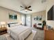 Comfortable bedroom featuring a ceiling fan, large windows, and tasteful neutral decor at 137 Drayton Ave, Davenport, FL 33837