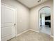 Neutral entryway featuring tile floors, a white door, and an archway leading into the kitchen at 137 Drayton Ave, Davenport, FL 33837