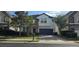 Charming two-story home with a stone facade, paver driveway, lush landscaping, and a two-car garage at 137 Drayton Ave, Davenport, FL 33837
