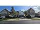 Charming two-story home with a stone facade, paver driveway, lush landscaping, and a two-car garage at 137 Drayton Ave, Davenport, FL 33837