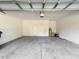 Clean and well-lit garage with a white door leading to the house, offering utility and storage at 137 Drayton Ave, Davenport, FL 33837