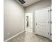 Hallway with tile flooring showcasing access to different rooms through white doors at 137 Drayton Ave, Davenport, FL 33837
