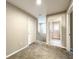 Upstairs hallway showcasing neutral walls, carpeted floors, and doors leading to various rooms at 137 Drayton Ave, Davenport, FL 33837