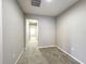 Neutral hallway leading to a bedroom or bathroom with carpet flooring and light-colored walls at 137 Drayton Ave, Davenport, FL 33837