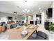 Open-concept living and dining area with modern furnishings and stainless steel kitchen appliances at 137 Drayton Ave, Davenport, FL 33837