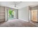 Bedroom featuring neutral carpet, a balcony, in-wall shelving and an attached bathroom at 1400 Lake Shadow Cir # 10104, Maitland, FL 32751