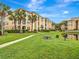 Condominium exterior surrounded by palm trees, lush landscaping, and a charming pond at 1400 Lake Shadow Cir # 10104, Maitland, FL 32751