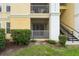 Exterior view of building featuring private screened in patio and stairs at 1400 Lake Shadow Cir # 10104, Maitland, FL 32751