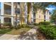 Multi-story condo building with well-maintained landscaping and convenient stair access at 1400 Lake Shadow Cir # 10104, Maitland, FL 32751
