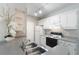 Kitchen featuring white cabinets, neutral countertops, stainless sink, and modern appliances at 1400 Lake Shadow Cir # 10104, Maitland, FL 32751