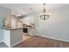A kitchen with white cabinetry, modern lighting, and a breakfast bar at 1400 Lake Shadow Cir # 10104, Maitland, FL 32751