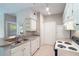 Kitchen featuring white cabinets, neutral countertops, and modern appliances at 1400 Lake Shadow Cir # 10104, Maitland, FL 32751