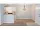 Bright living area with an open view of the kitchen and a decorative chandelier at 1400 Lake Shadow Cir # 10104, Maitland, FL 32751