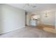 Open-concept living area with neutral carpet, chandelier, and view into the kitchen at 1400 Lake Shadow Cir # 10104, Maitland, FL 32751