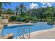 Resort-style swimming pool with lush landscaping and comfortable lounge chairs for relaxation at 1400 Lake Shadow Cir # 10104, Maitland, FL 32751