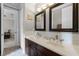 Bathroom featuring double sinks with a white countertop and dark wood cabinets at 14038 Bluebird Park Rd, Windermere, FL 34786