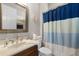 Bathroom featuring a sink, toilet and shower, decorated with blue accents at 14038 Bluebird Park Rd, Windermere, FL 34786