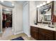 Bathroom with vanity, closet access, and ample natural light at 14038 Bluebird Park Rd, Windermere, FL 34786