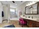 Bright bathroom featuring a soaking tub, tiled shower, vanity, and stylish fixtures at 14038 Bluebird Park Rd, Windermere, FL 34786
