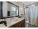 Bathroom featuring single sink with dark wood cabinet and a shower with curtain at 14038 Bluebird Park Rd, Windermere, FL 34786