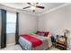 Cozy bedroom with neutral walls, a ceiling fan, and a window with curtains at 14038 Bluebird Park Rd, Windermere, FL 34786