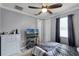 Bedroom with neutral walls, a ceiling fan, TV, and ample closet space at 14038 Bluebird Park Rd, Windermere, FL 34786
