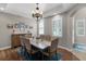 Elegant dining room with tray ceiling, chandelier, plantation shutters, and wood floors at 14038 Bluebird Park Rd, Windermere, FL 34786