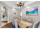 Bright dining room featuring wood floors, chandelier, and serene beach-themed decor at 14038 Bluebird Park Rd, Windermere, FL 34786