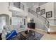 Bright living room with a staircase, iron railing, and view of the outdoor pool at 14038 Bluebird Park Rd, Windermere, FL 34786