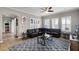 Cozy living room featuring plantation shutters, a comfortable leather sectional, and stylish decor at 14038 Bluebird Park Rd, Windermere, FL 34786