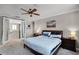 Well-lit main bedroom featuring an ensuite, neutral paint, and large windows at 14038 Bluebird Park Rd, Windermere, FL 34786