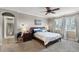 Comfortable main bedroom with a ceiling fan, bedside tables, and neutral decor at 14038 Bluebird Park Rd, Windermere, FL 34786