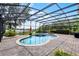 Backyard featuring pool, hot tub, brick patio, and enclosed screened area at 14038 Bluebird Park Rd, Windermere, FL 34786