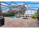 Backyard showcasing a pool, hot tub, and fire pit with a screened-in enclosure at 14038 Bluebird Park Rd, Windermere, FL 34786