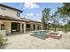 Spacious backyard featuring an in-ground pool, spa, covered patio, and lush landscaping at 1425 Dunbrooke Loop, Longwood, FL 32779