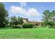 Expansive backyard featuring a lush lawn and mature trees, perfect for outdoor activities and relaxation at 1425 Dunbrooke Loop, Longwood, FL 32779