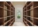Walk-in closet with wood shelving and window at 1425 Dunbrooke Loop, Longwood, FL 32779