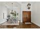 Elegant dining room featuring a high ceiling, large window, and hardwood floors at 1425 Dunbrooke Loop, Longwood, FL 32779